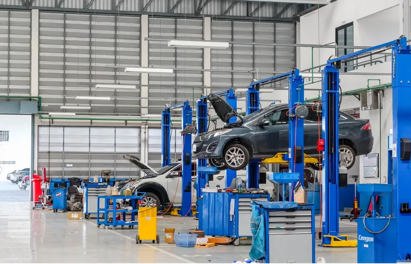 Envision Motors Fleet service bay with vehicles on lifts being serviced and upfitted